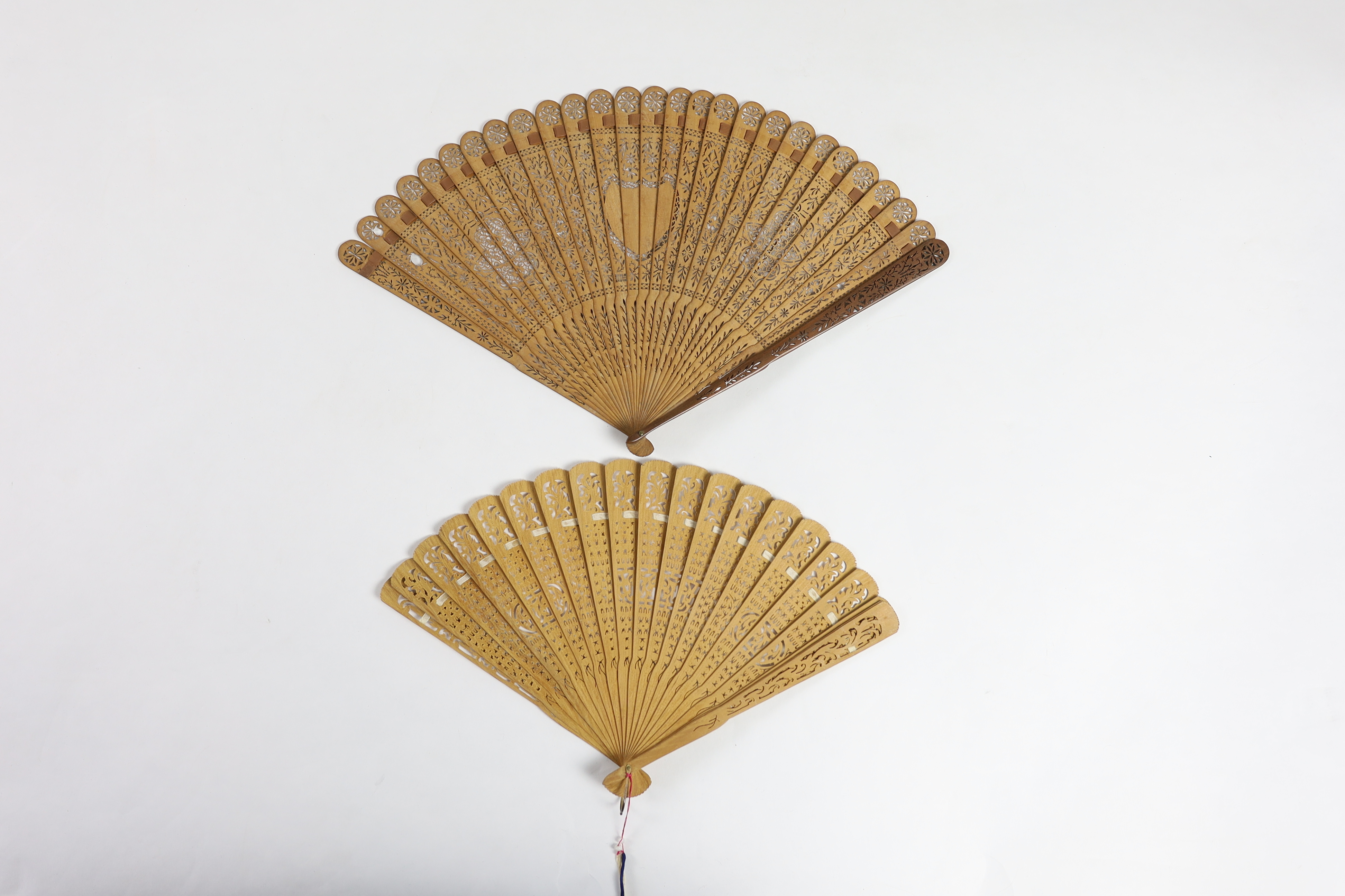 A 19th century Chinese sandalwood brisé fan and a smaller 20th century Chinese sandalwood fan